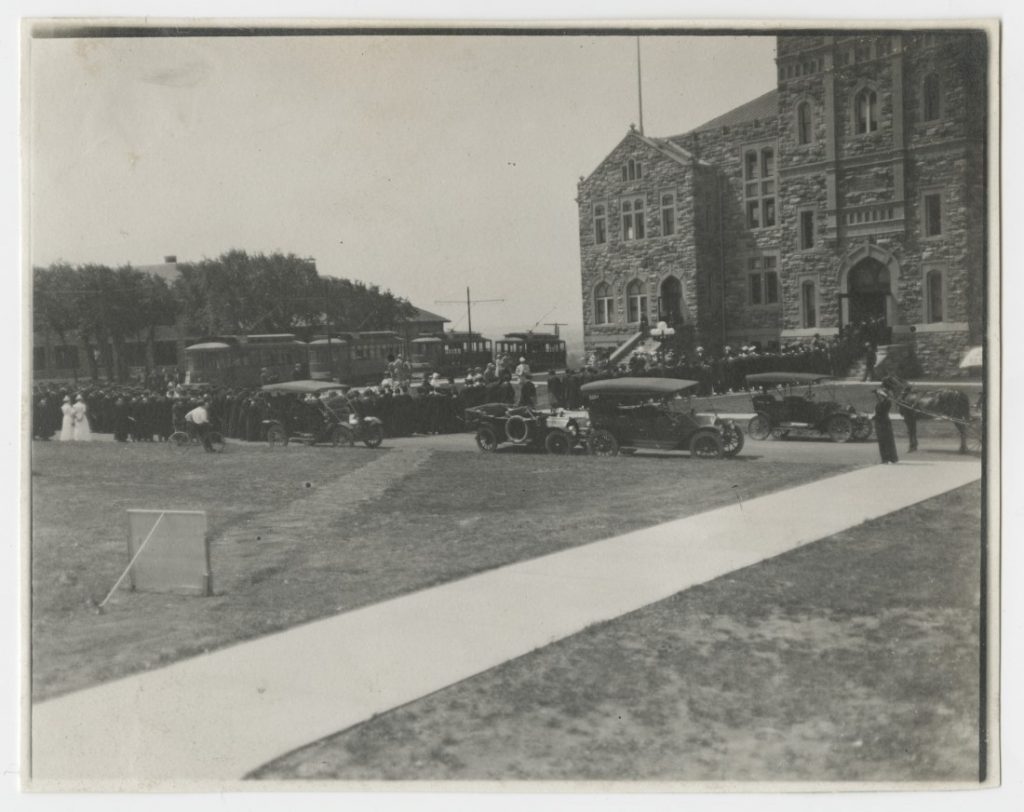 Photograph of KU graduates walking into Robinson Gymnasium on Commencement Day, 1913