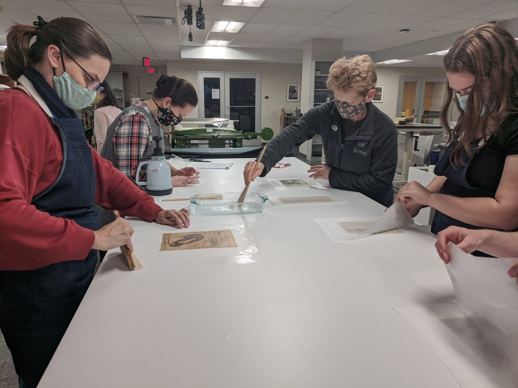 Conservation Services staff and student employees practice a double-sided lining technique taught by visiting conservator Minah Song. Kenneth Spencer Research Library, The University of Kansas.