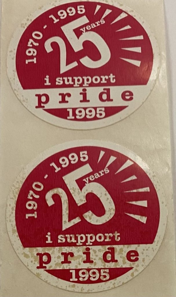 Two circular stickers with primarily white text against a red background.
