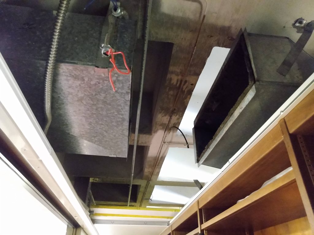 Gap in ductwork where old heater has been removed, before new heater has been installed.