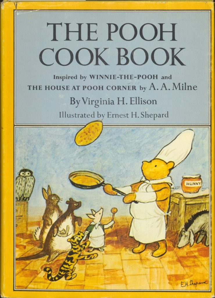 This image contains the text of the book's title and author. The background is a color illustration of Winnie-the-Pooh in a chef's outfit, flipping a pancake in a pan while Piglet, Eeyore, and other friends gather around him.