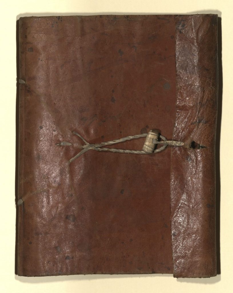 Dark brown leather book cover, tied together with string or rope.