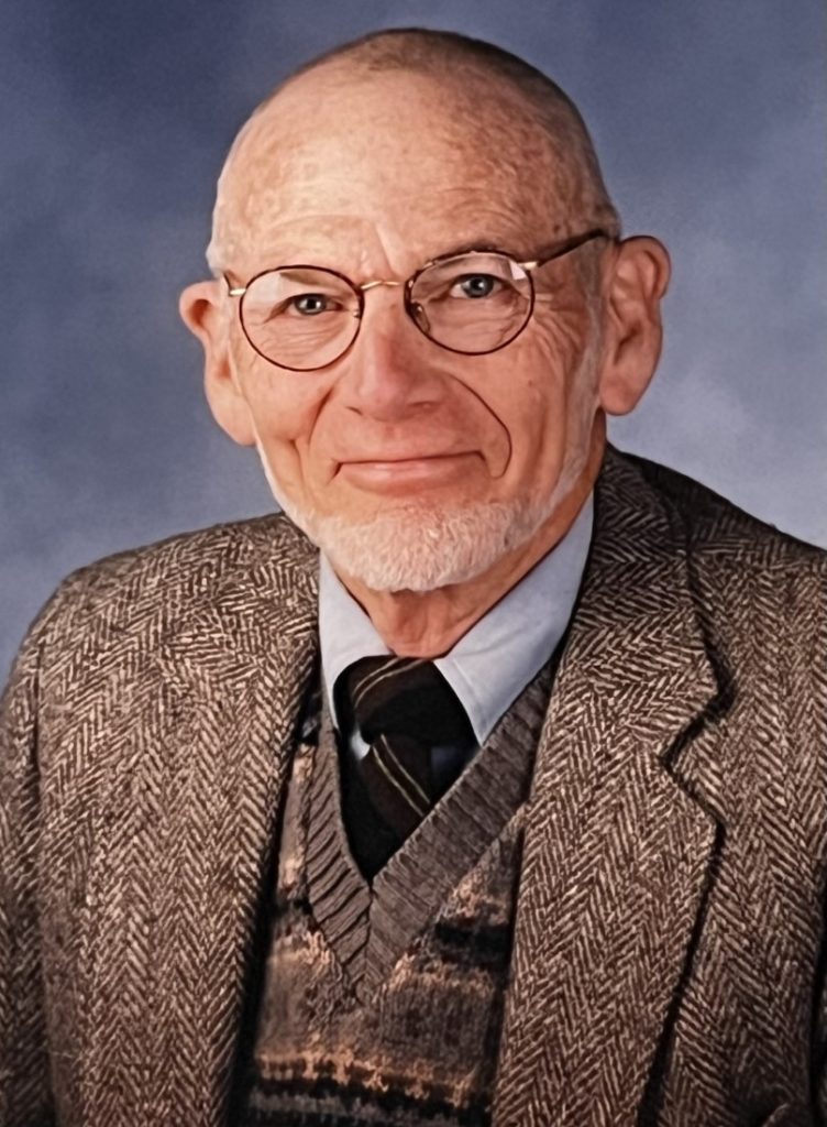 Headshot of an older man with glasses.