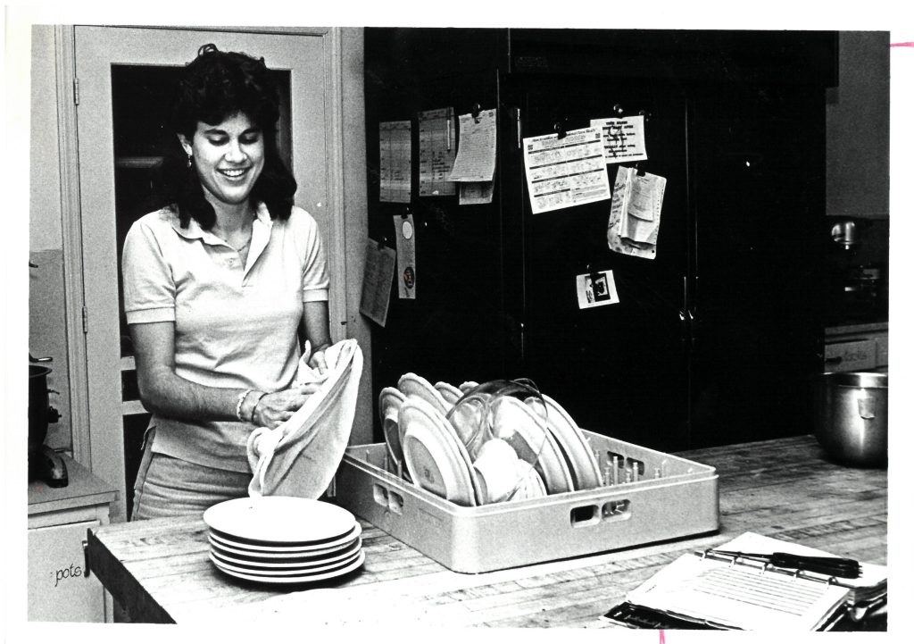 Woman washing dishes.