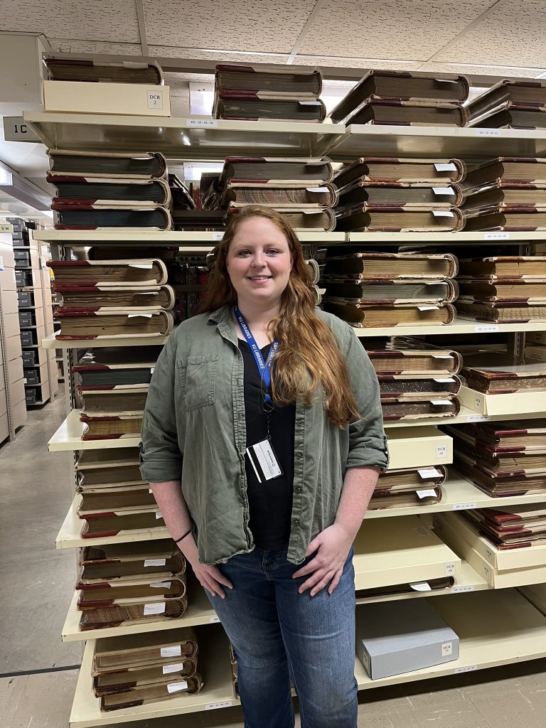 Special Collections Serials Cataloger Ruby Rhodd pictured in the Kansas Collection Stacks.