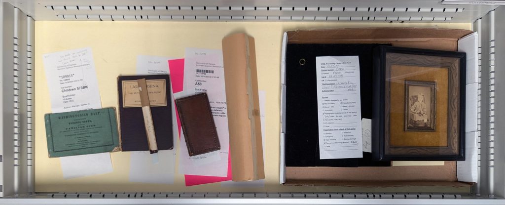 Items awaiting treatment in special collections conservator's cabinet drawer.