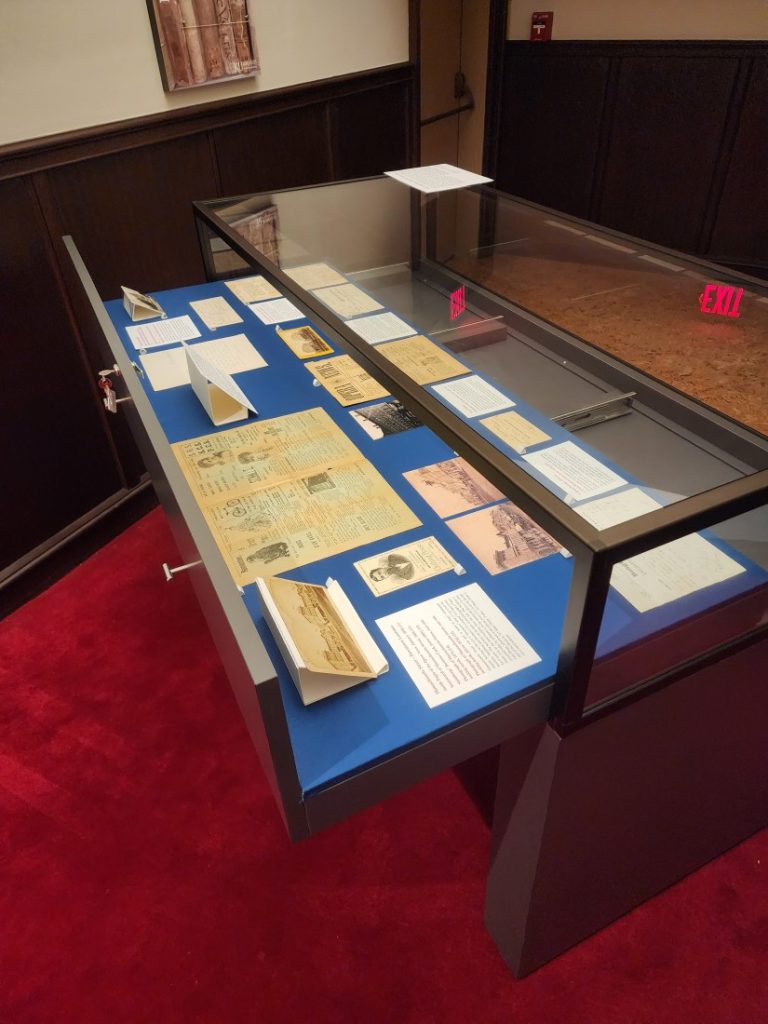 An open exhibit case with items inside.