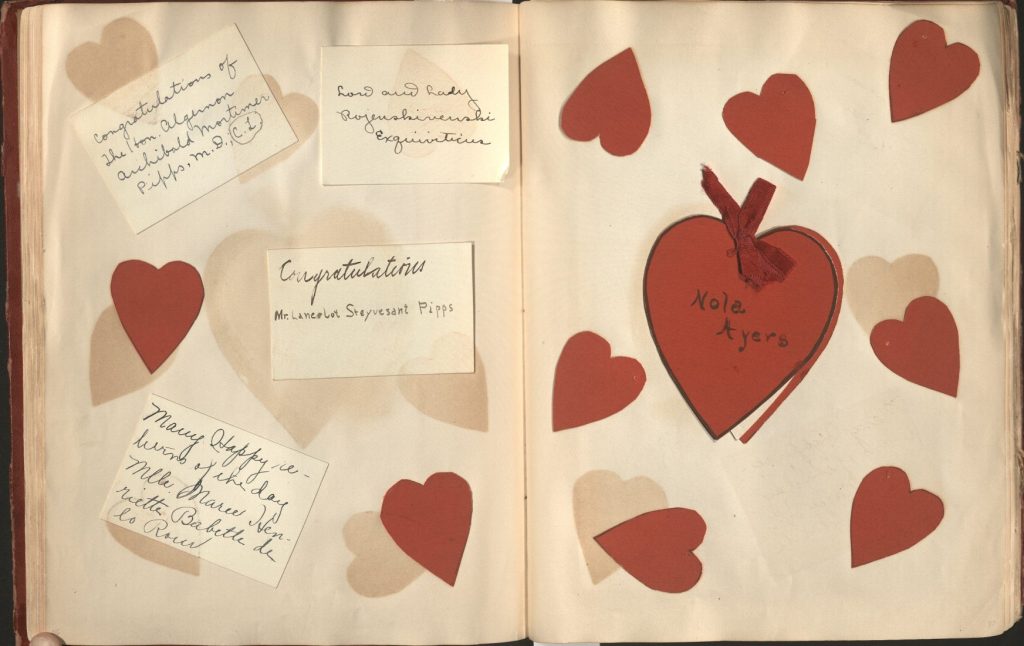 Two-page scrapbook page with Valentine's notes and red paper hearts.