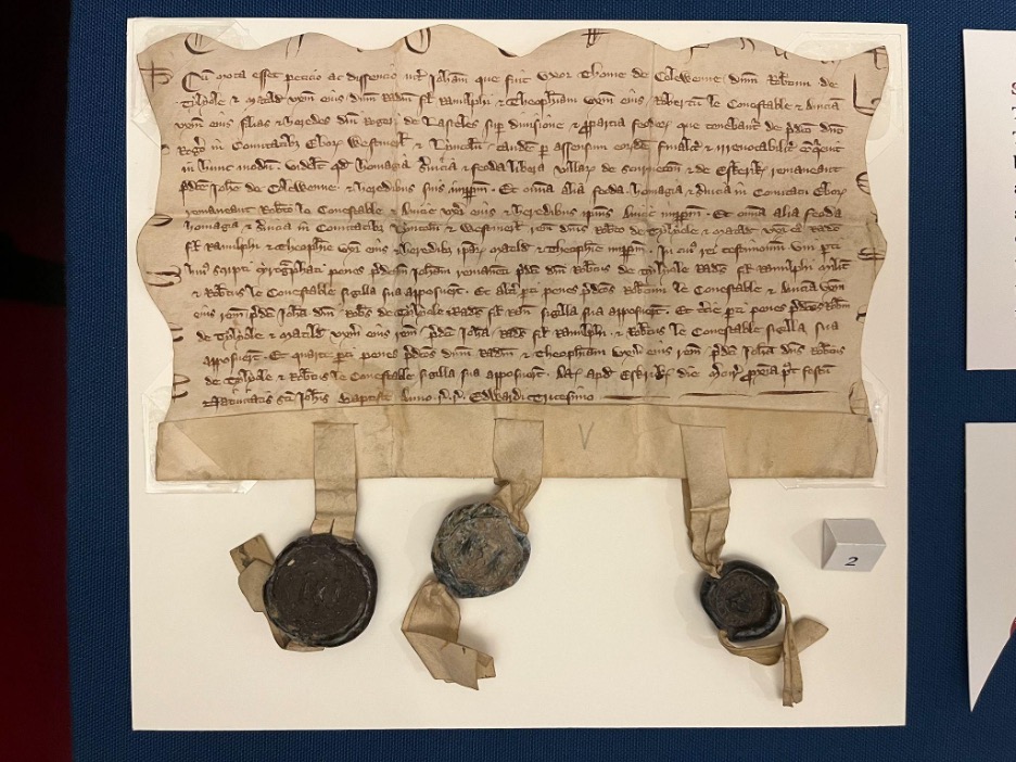 Large handwritten document with wavy edges and three seals attached at the bottom.
