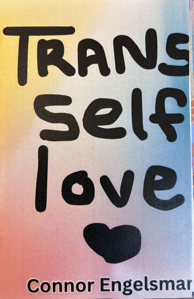 Front cover of the zine, which has the title and the author's name in black text with a large black heart, all against a multicolored background.