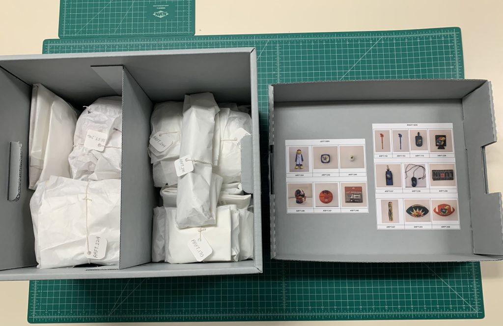 Plastic artifacts pictured after rehousing, individually wrapped and numbered with a photographic key affixed to the inner lid of the box.