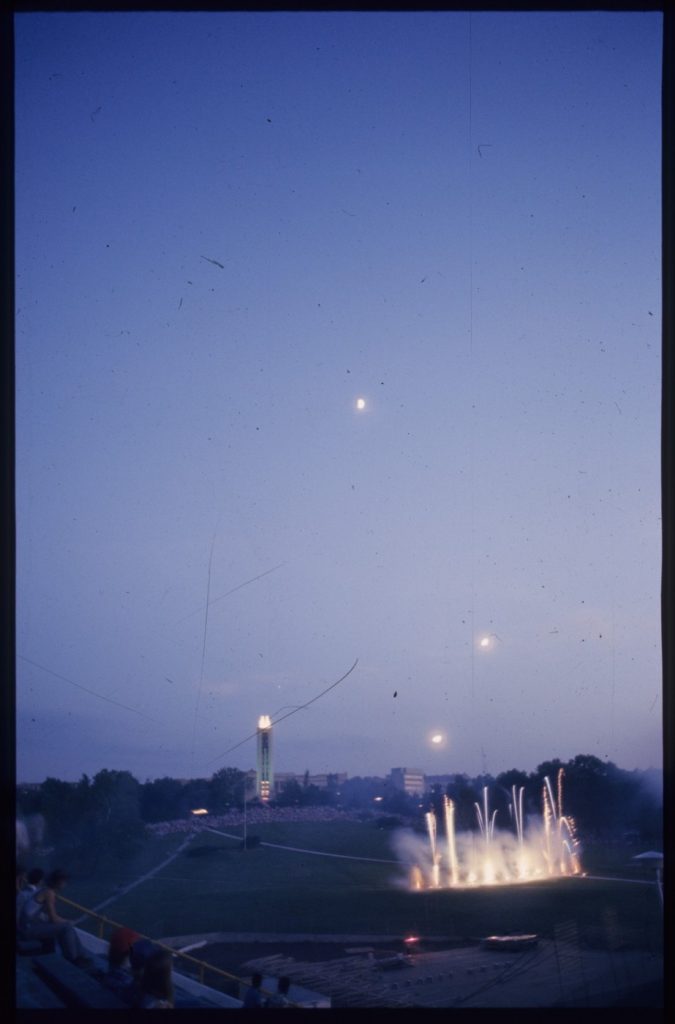 Color photograph of fireworks being lit from KU's Memorial Stadium. 