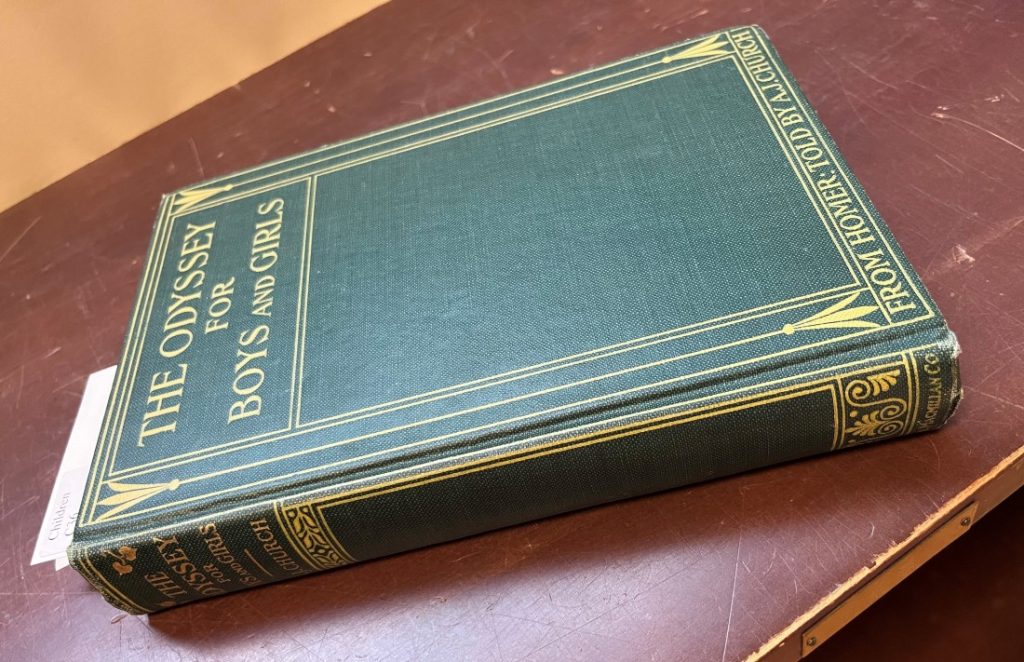 A book with a green cover and yellow text and decorations.