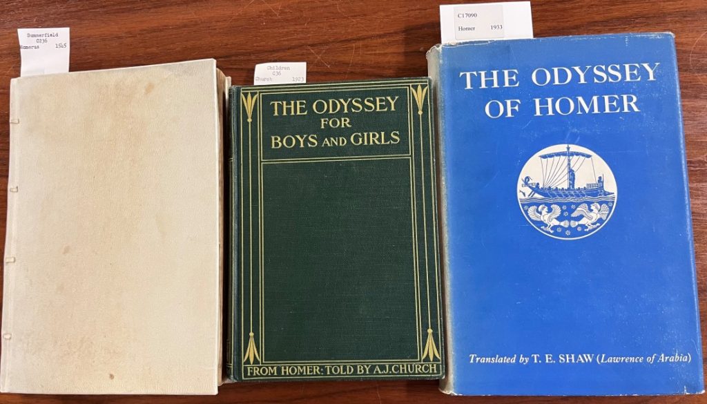 Three versions of The Odyssey, laying on a table in a row.